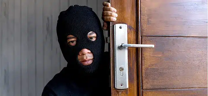 Burglar breaking in doors